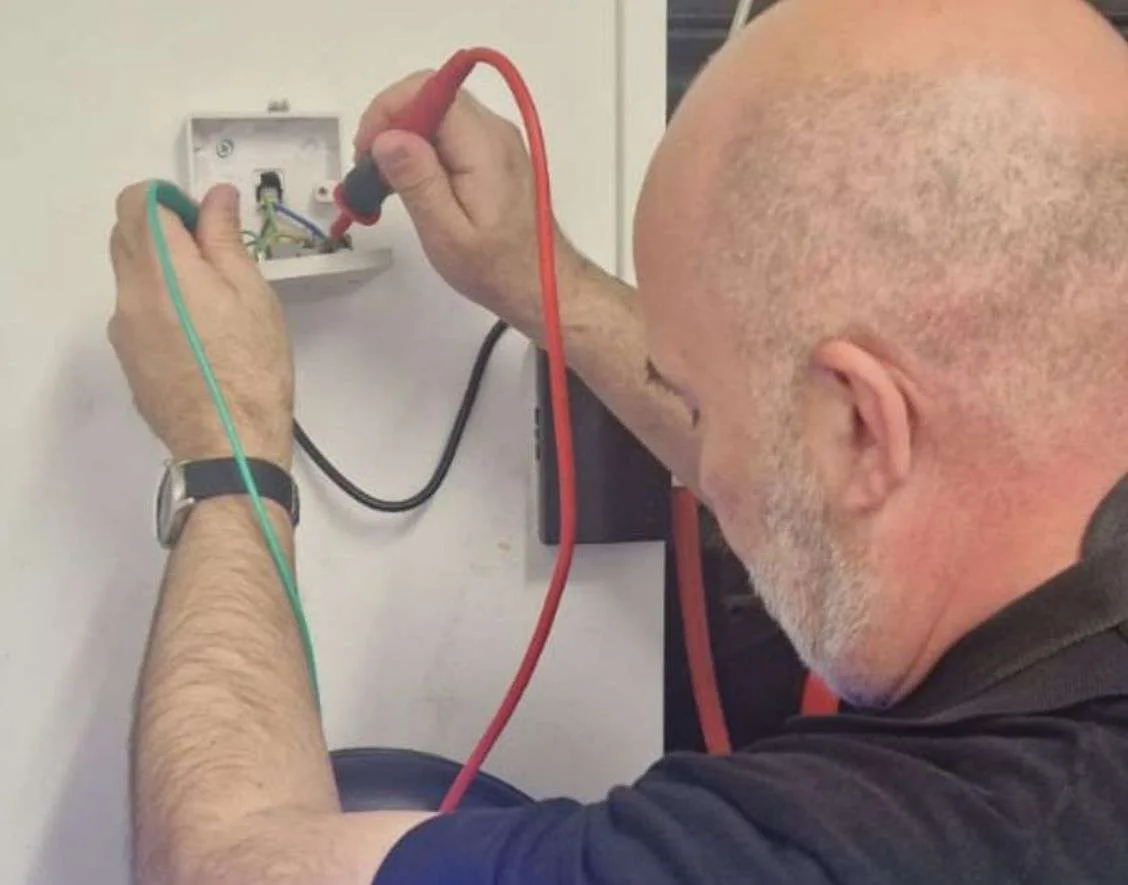 Electrician carrying out an electrical inspection in a London home