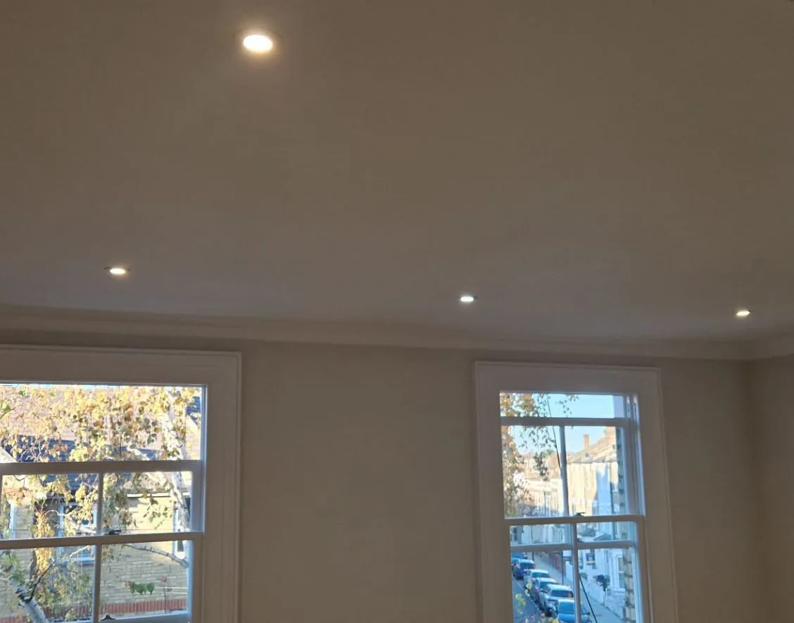 Grid layout of fire-rated LED downlights delivering uniform light across bedroom ceiling.
