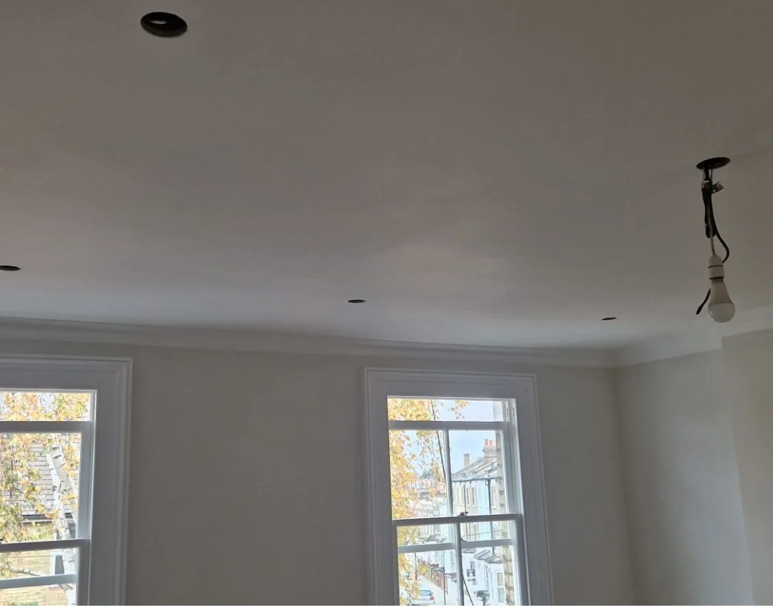 First-fix wiring and downlight cut-outs before fitting LEDs in Hammersmith bedroom.